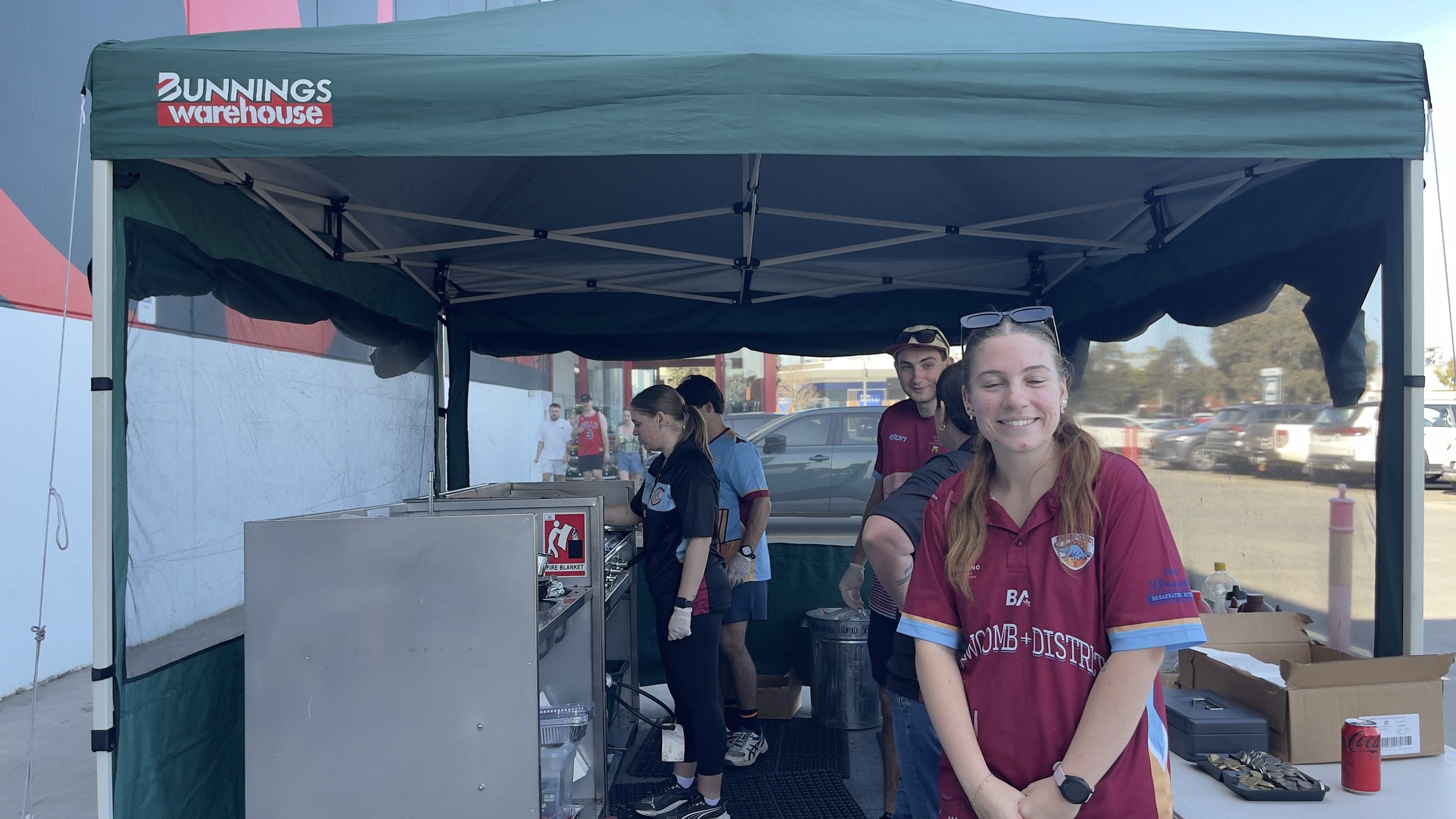 NDCC volunteers in club colours serving at the Bunnings Leopold barbecue.