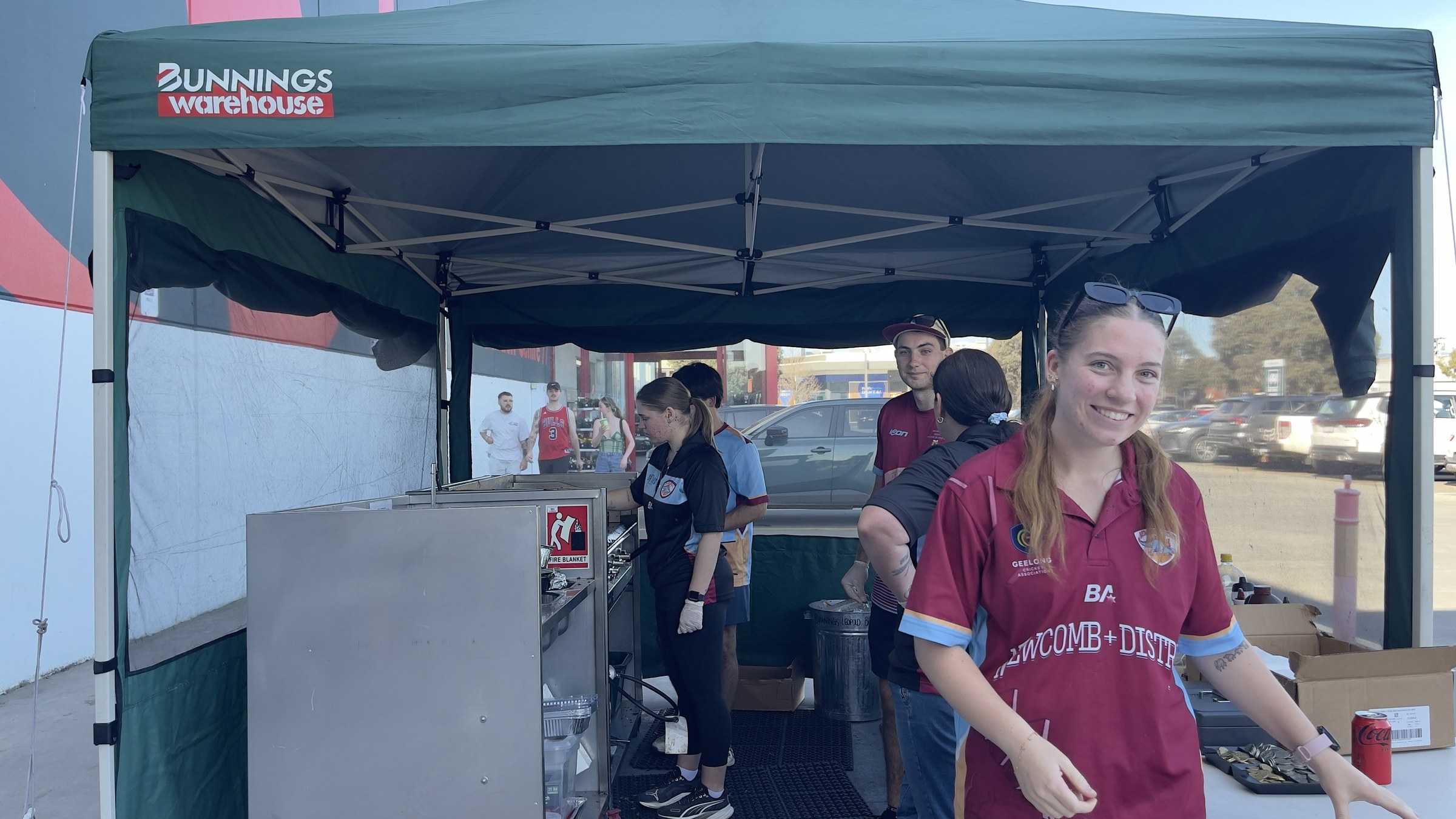 NDCC volunteers in club colours serving at the Bunnings Leopold barbecue.
