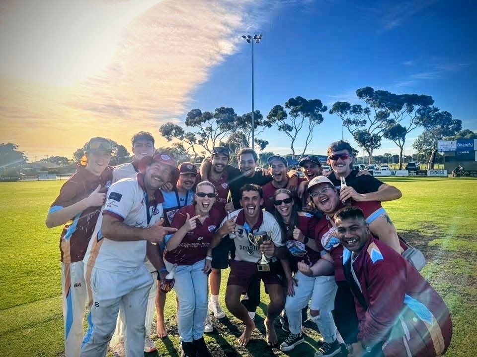 Players and supporters gathered for a premiership group photo in the late-afternoon sun.