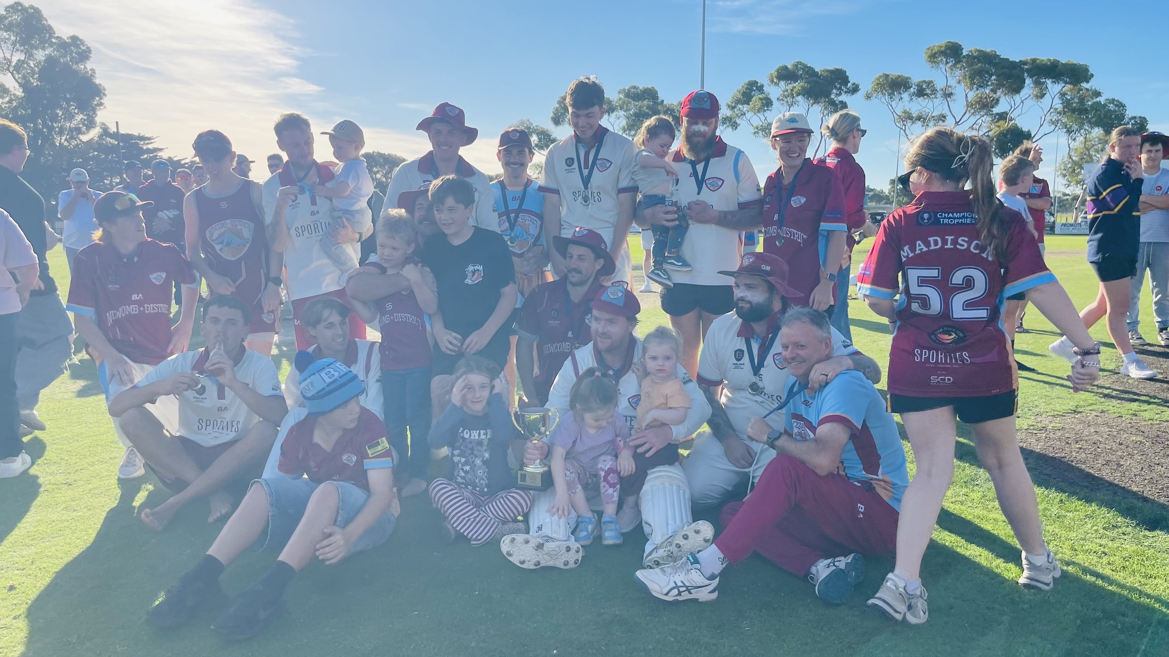 NDCC players and supporters gathering for a team photo on the oval after the grand final.