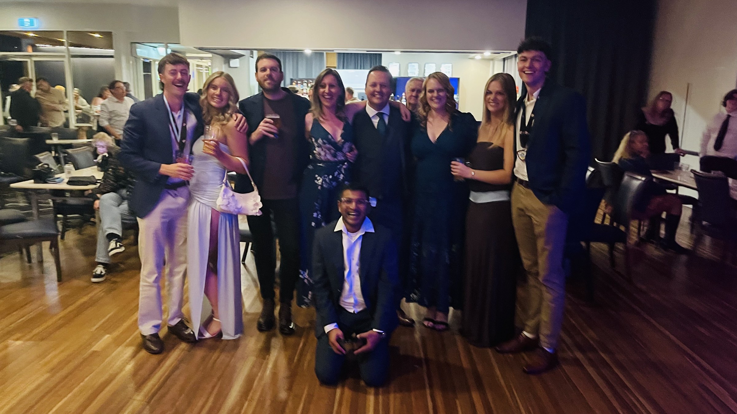 Club members and guests smiling together at presentation night.