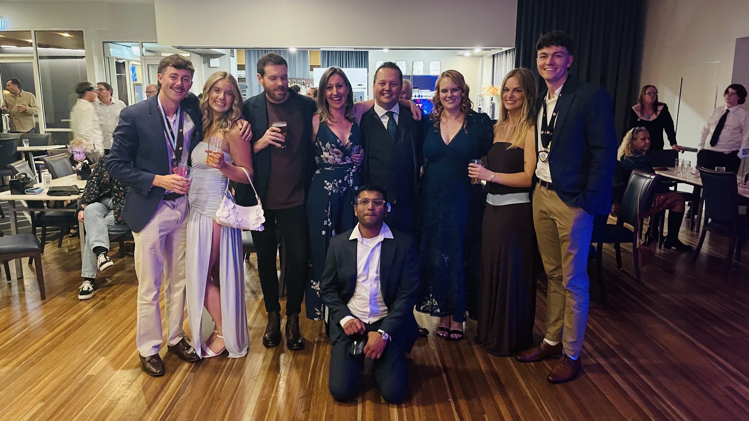 A group of club members and guests posing inside the presentation-night venue.